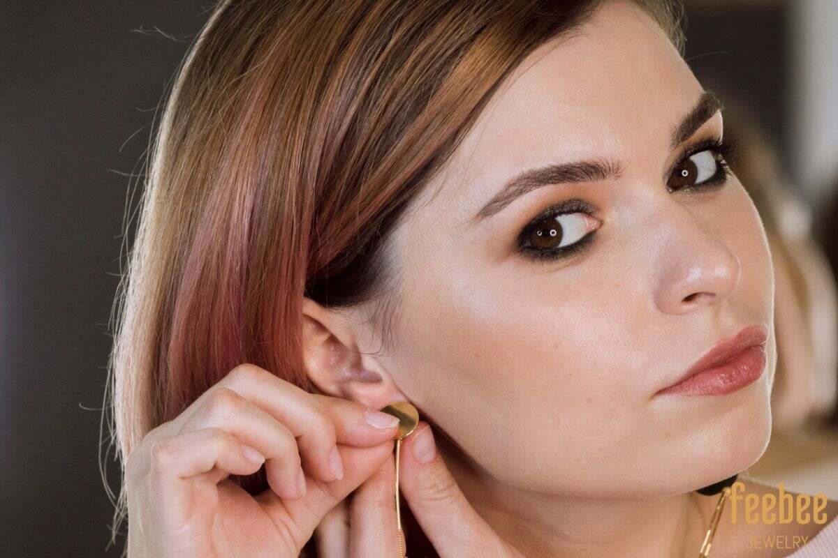 Woman putting on earrings